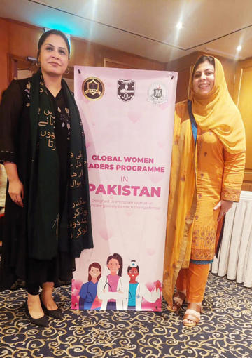Dr Wajiha Rizwan And Dr Mahwish Arooj Smiling Next To Banner